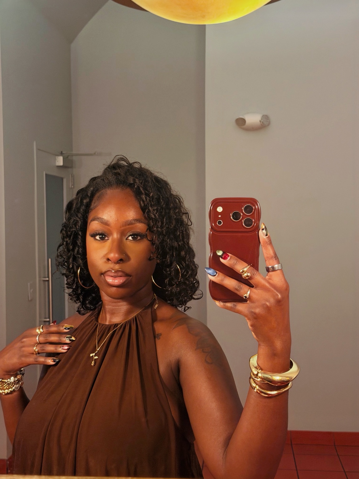 Jamelia showing her finished e.l.f. skin tint makeup look